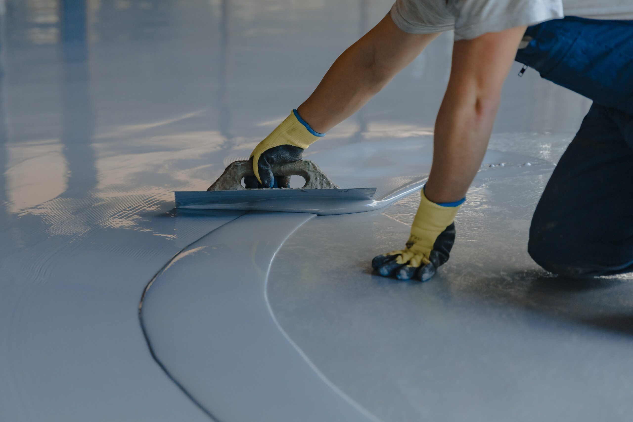 flooring tech applying epoxy coating