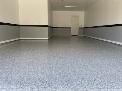 Epoxy and polyaspartic flake floor coating with grey accent walls in Southlake, Texas.
